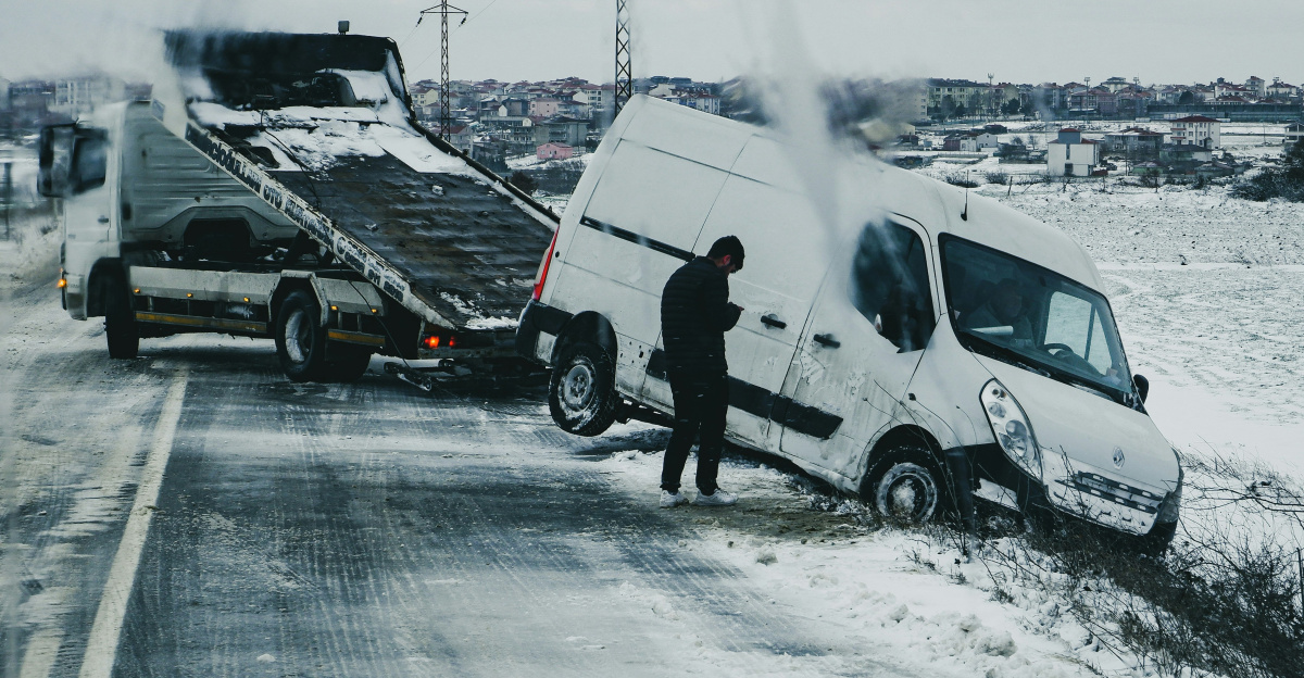 a man standing next to a white van on the side of a road