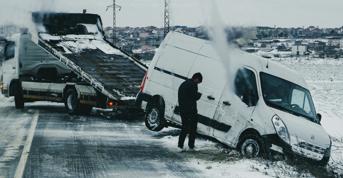 a man standing next to a white van on the side of a road