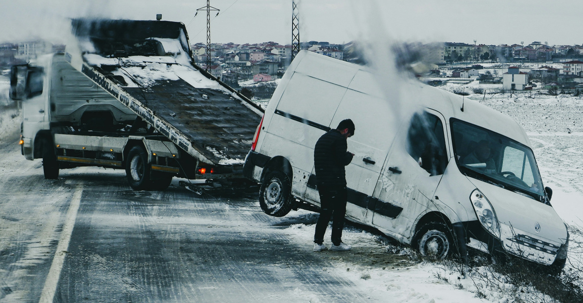 a man standing next to a white van on the side of a road