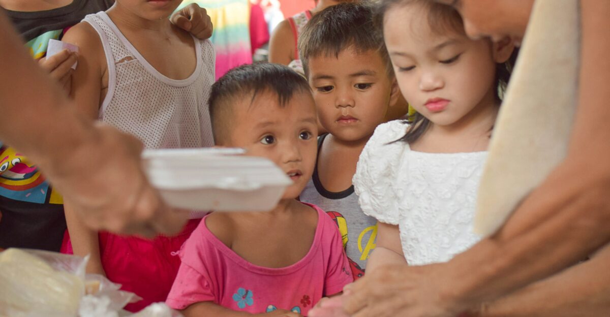 a group of children standing around each other