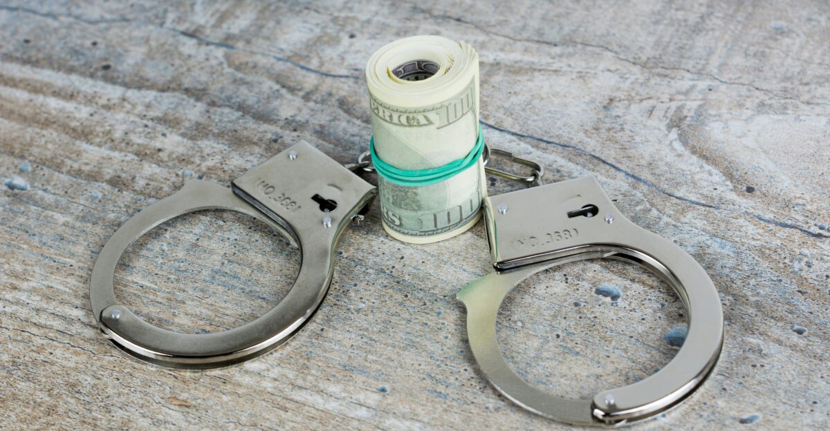 a pair of scissors and a roll of money on a table