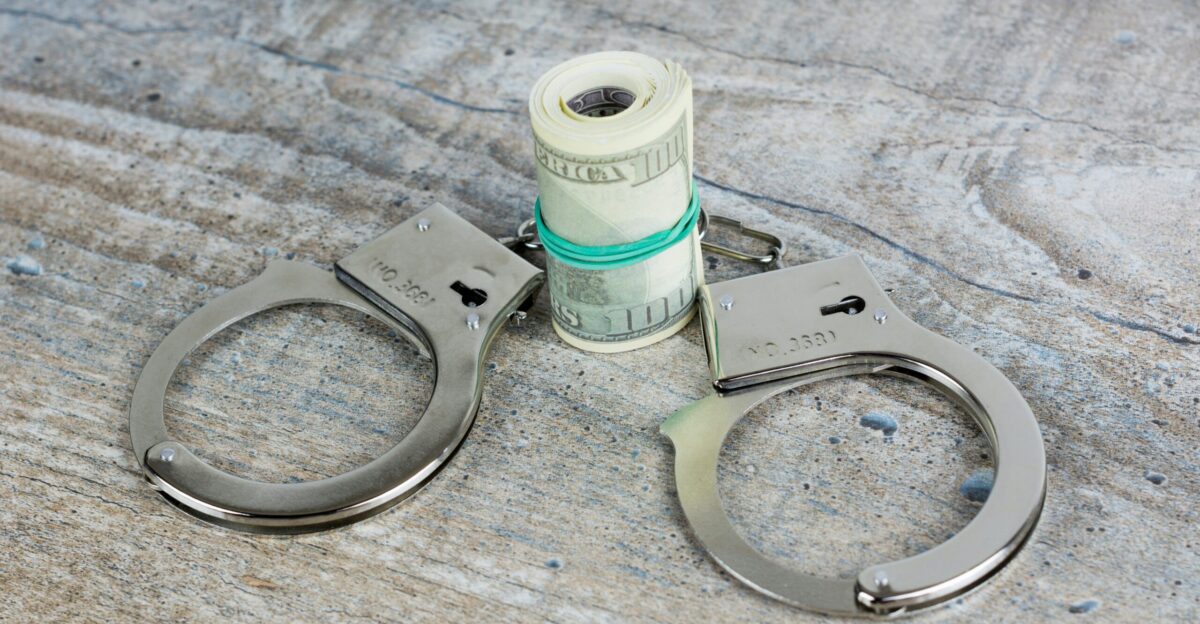 a pair of scissors and a roll of money on a table