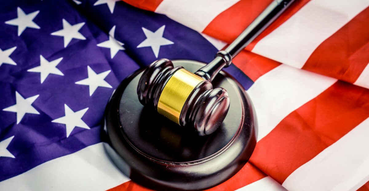 a judge s gavel on top of a flag