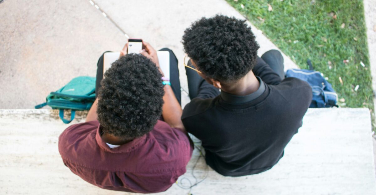 a couple of people sitting on top of a bench