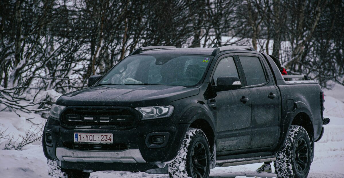 a black truck is parked in the snow