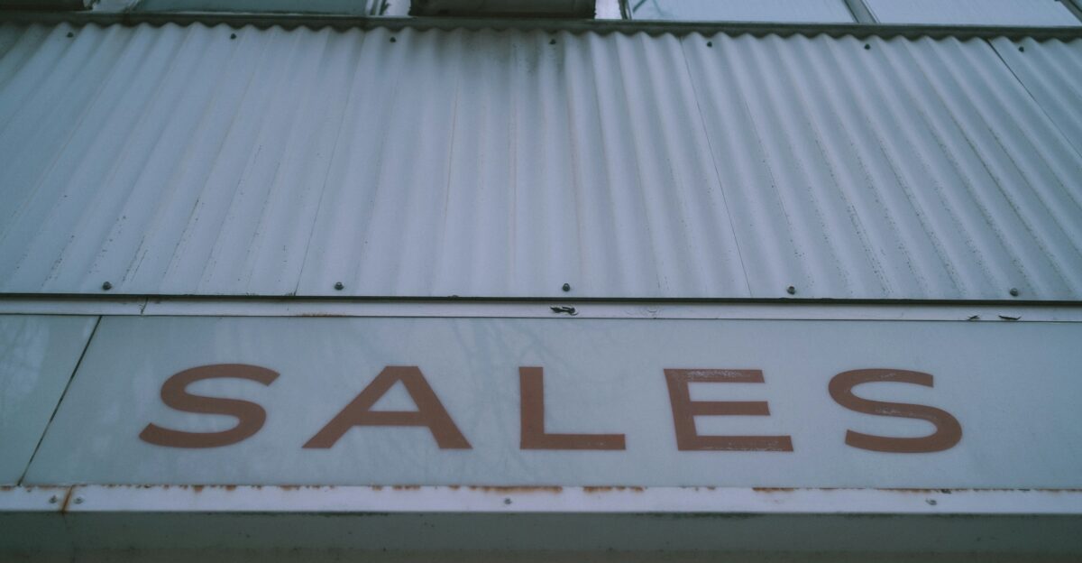 a sign that says sales on the side of a building