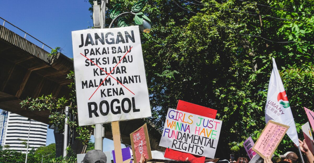 a group of people holding up signs in the air