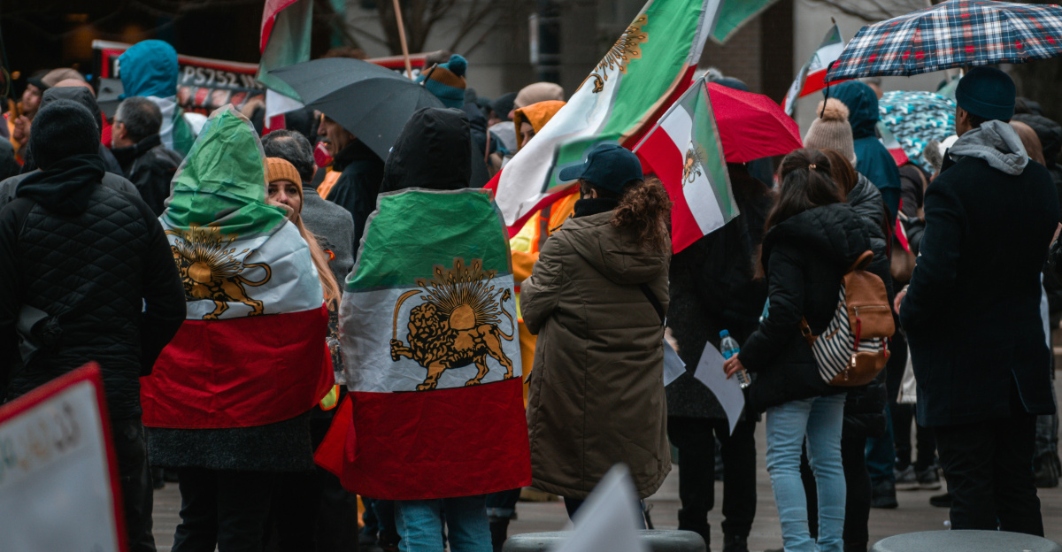 a group of people walking down a street holding flags