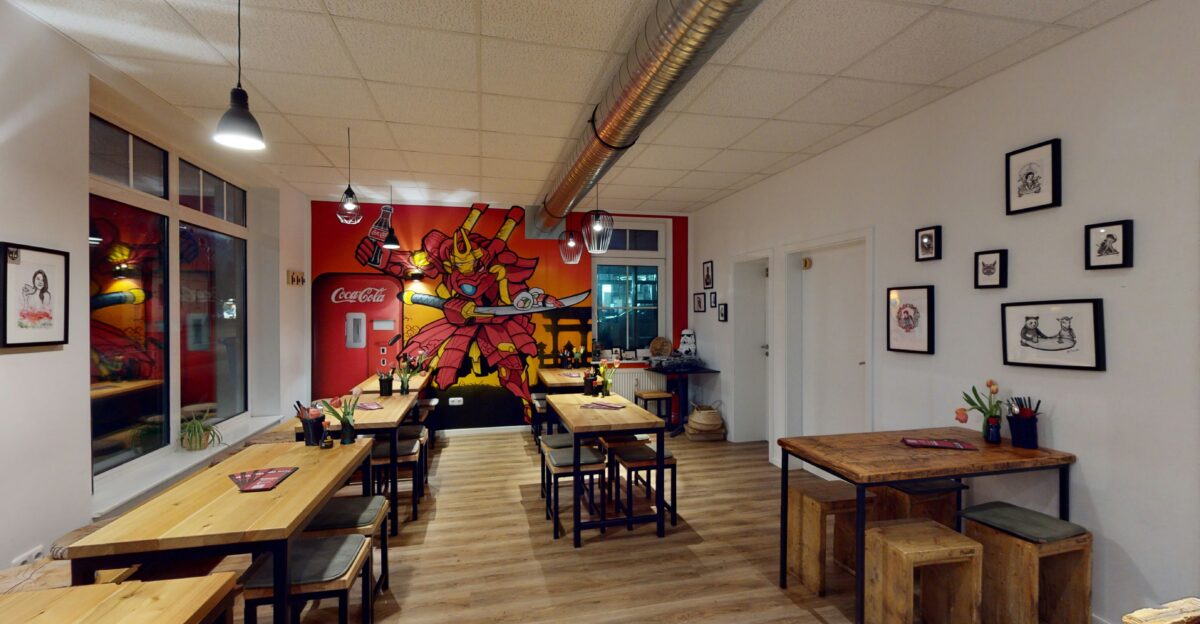 a restaurant with a large mural on the wall