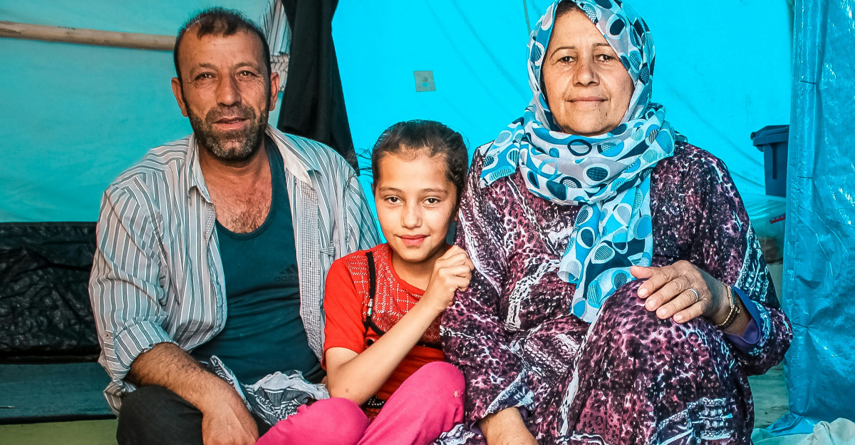 a man and a woman sitting next to a child