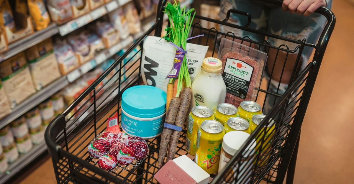 a person pushing a shopping cart full of food