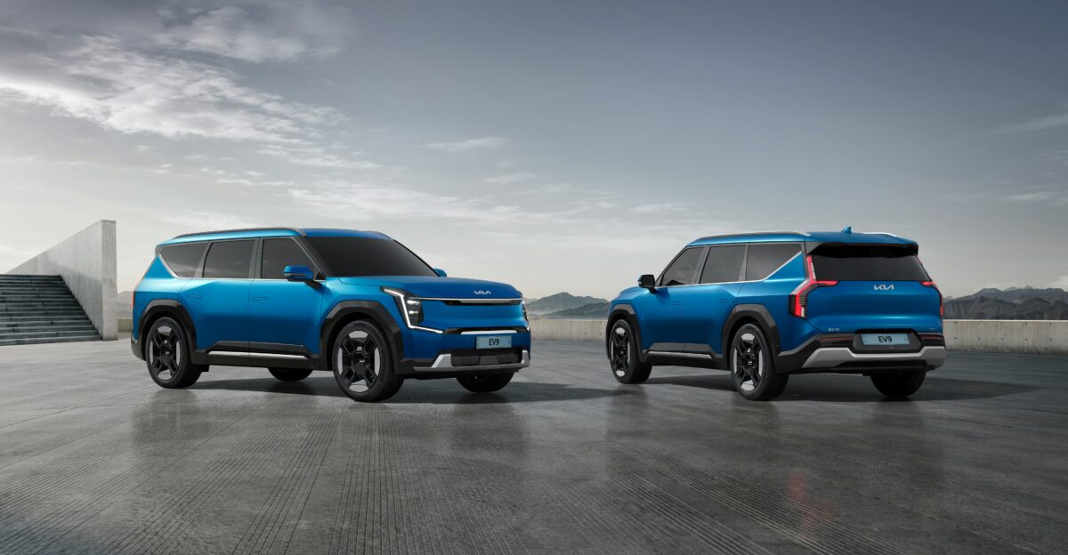 two blue suvs side by side in a parking lot