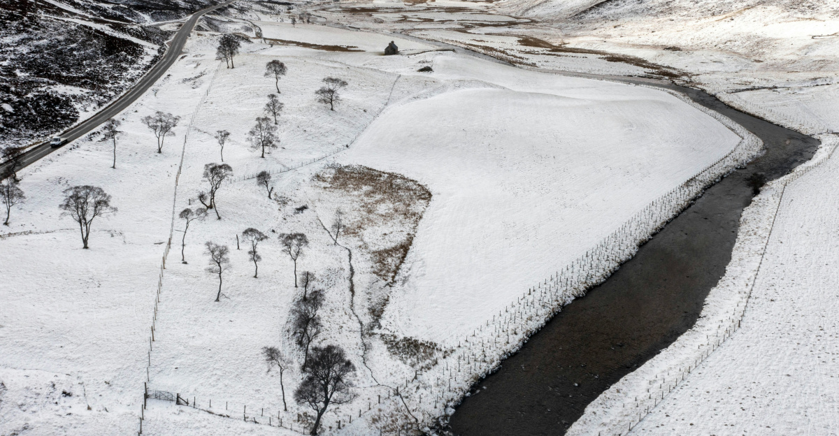 a river running through a snow covered valley