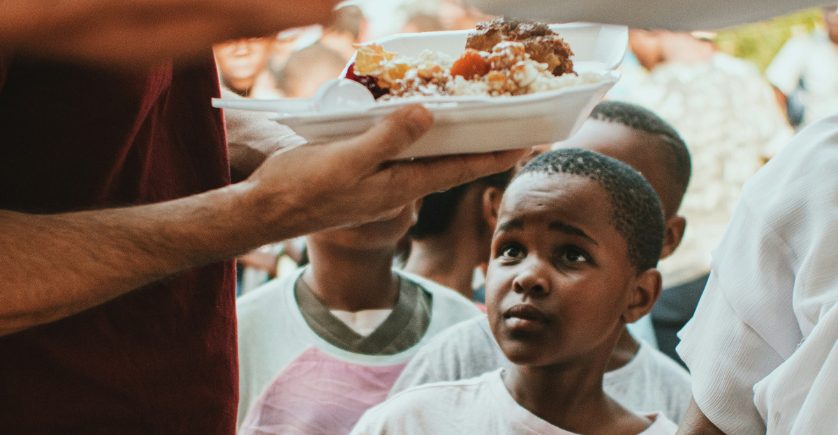 a group of people holding plates of food