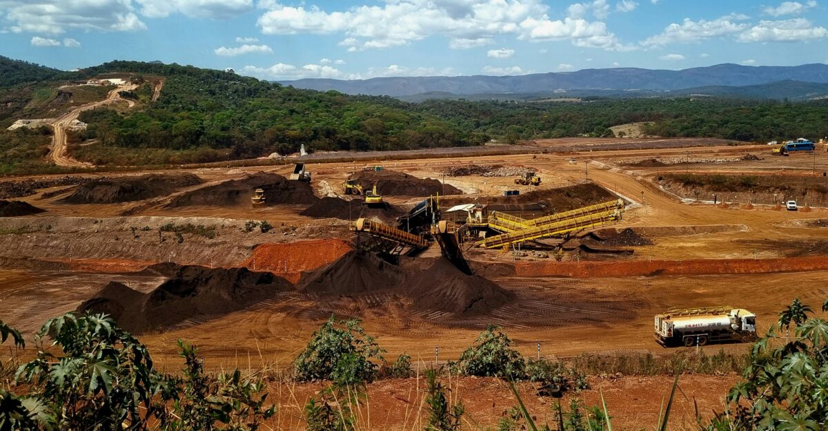 a construction site with a large amount of dirt in the foreground