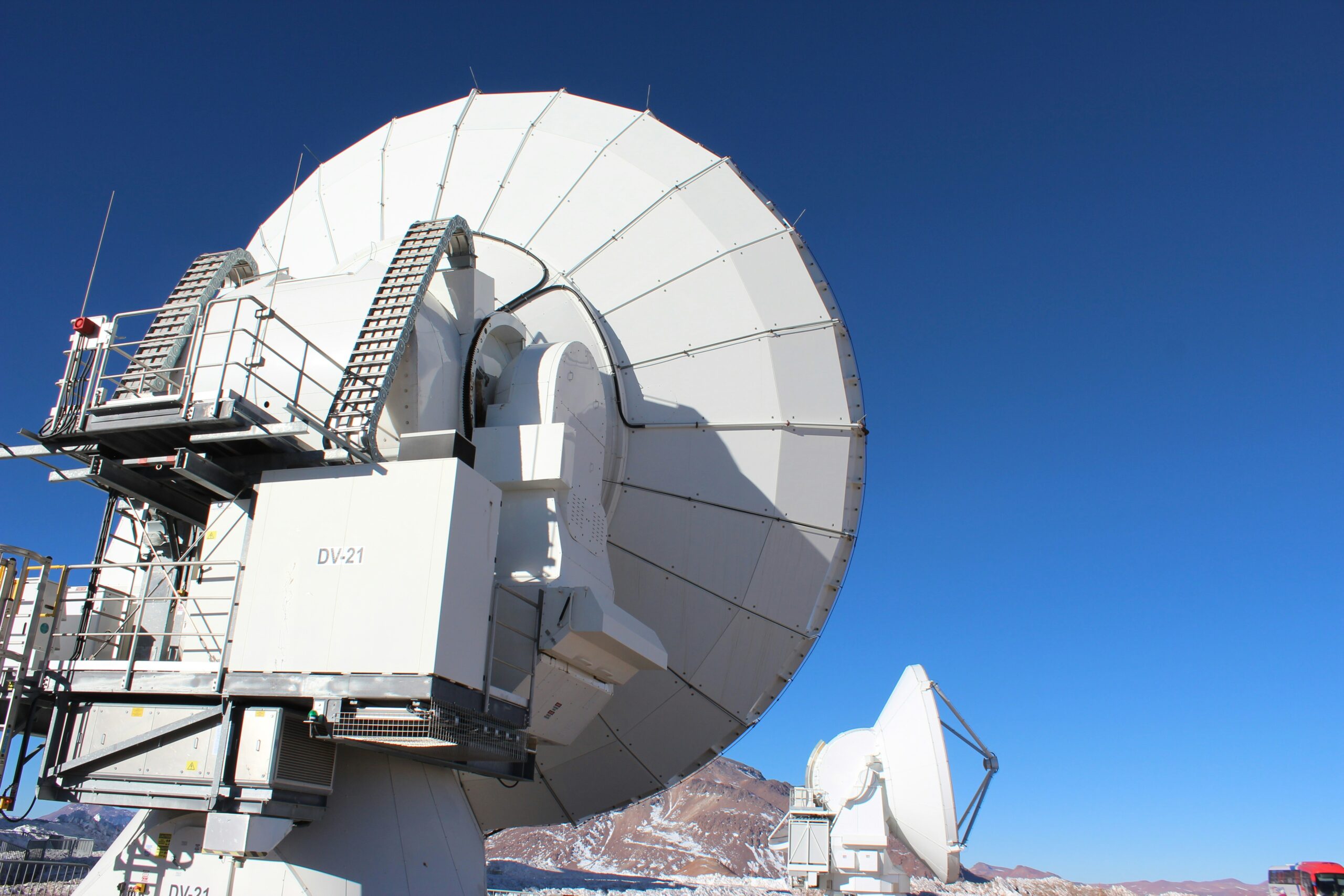 a large satellite dish sitting on top of a snow covered ground