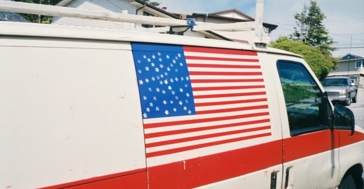 an american flag painted on the side of a van