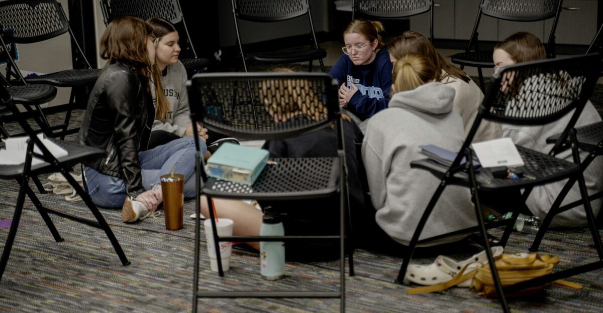 a group of girls sitting in a room next to each other