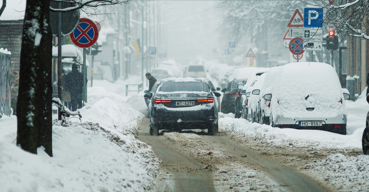 a car driving down a snow covered street