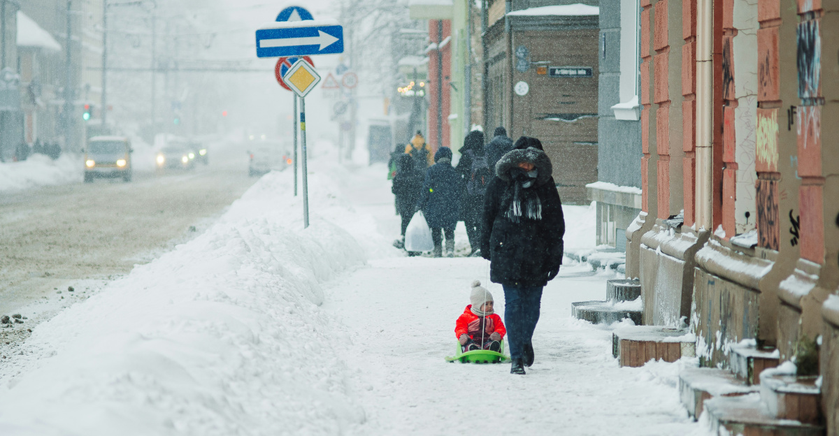 a group of people walking down a snow covered street