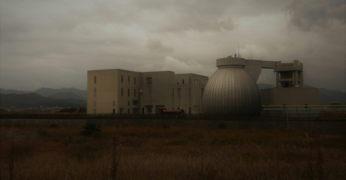 a large building sitting on top of a dry grass field