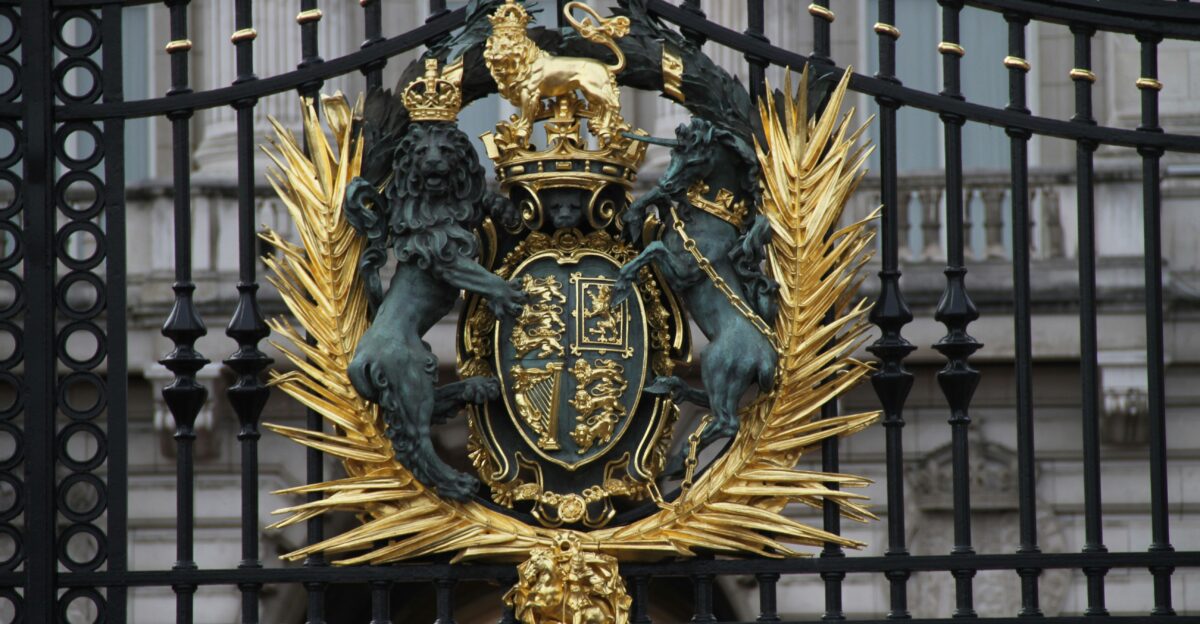 a gold and black coat of arms on a gate
