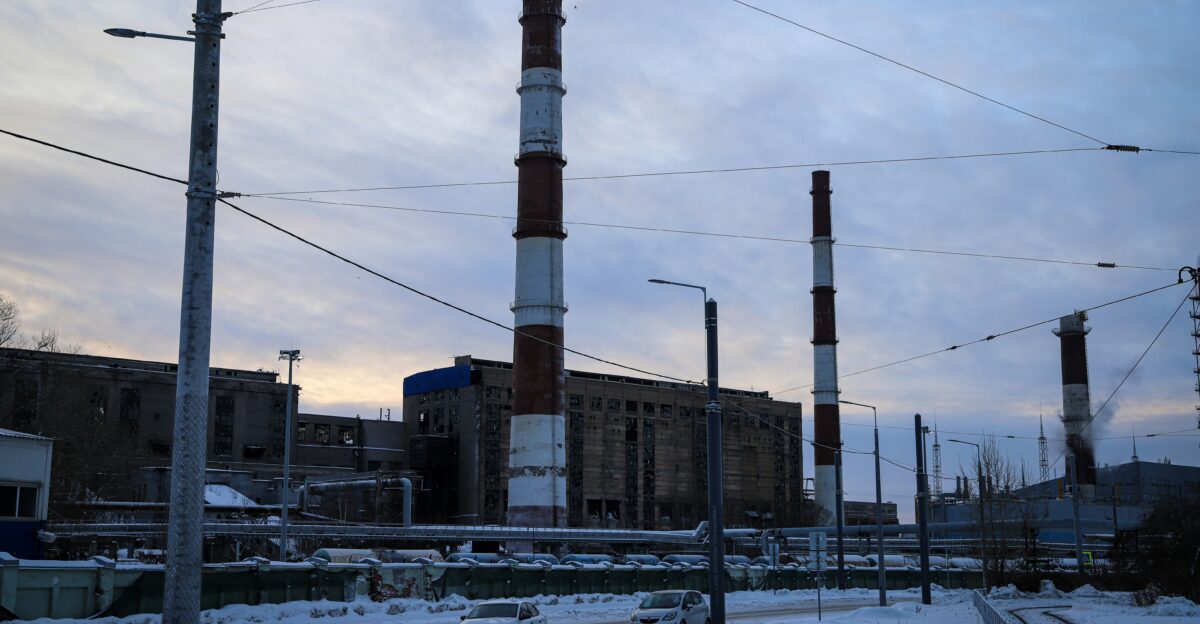 a factory with a lot of power lines in the background