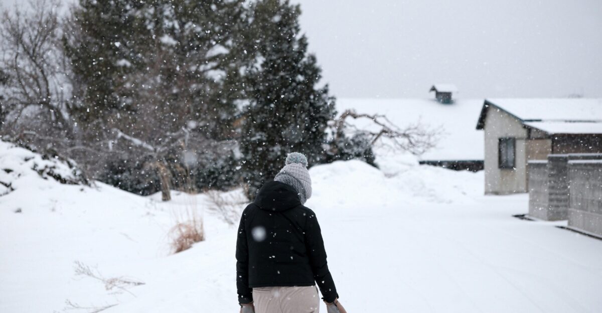 a person walking in the snow on a pair of skis