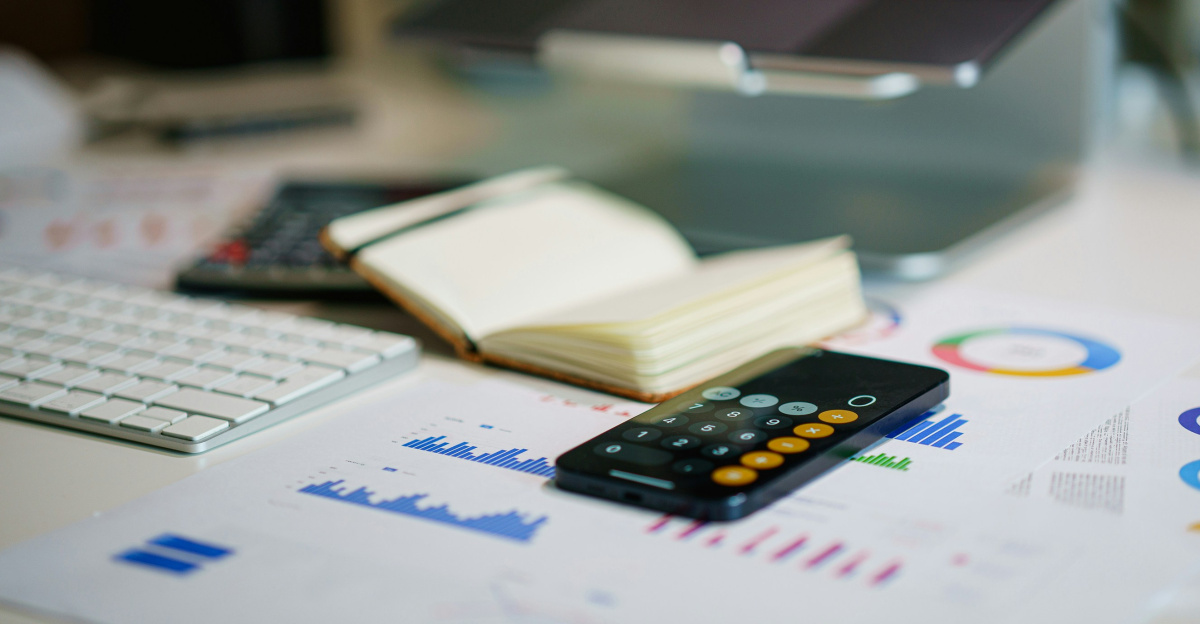a remote control sitting on top of a table next to a book