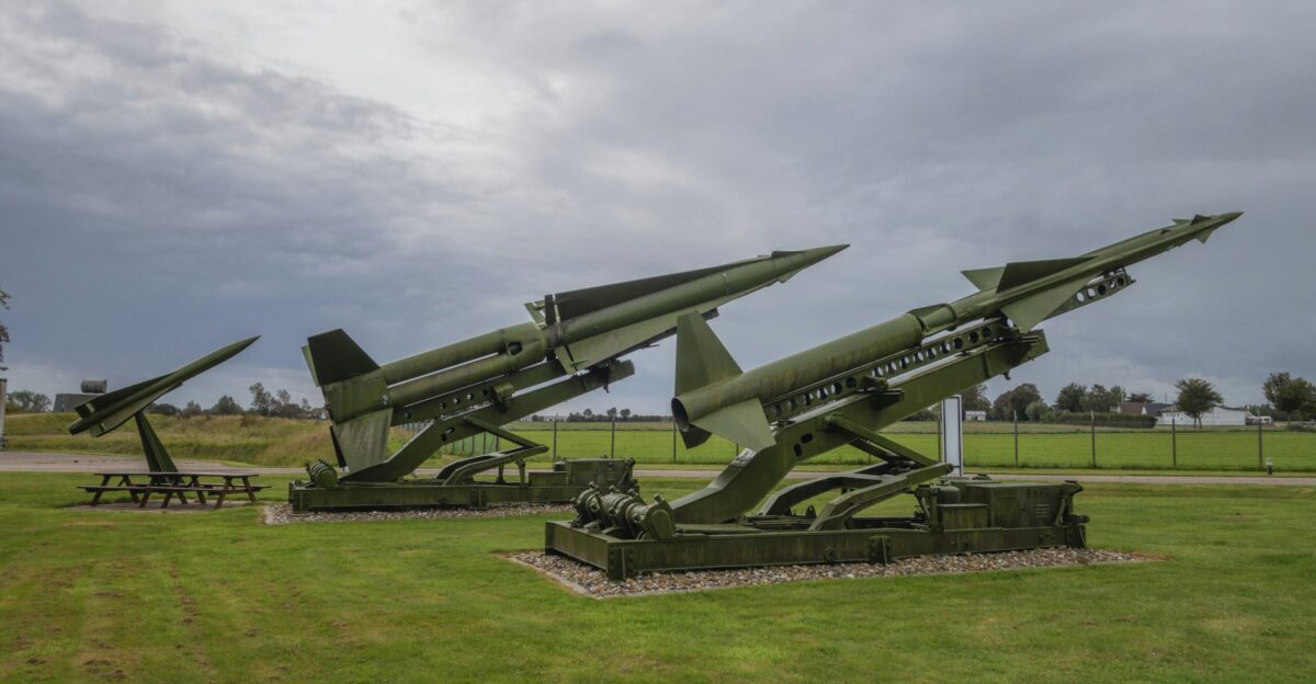 a group of military missiles sitting on top of a field