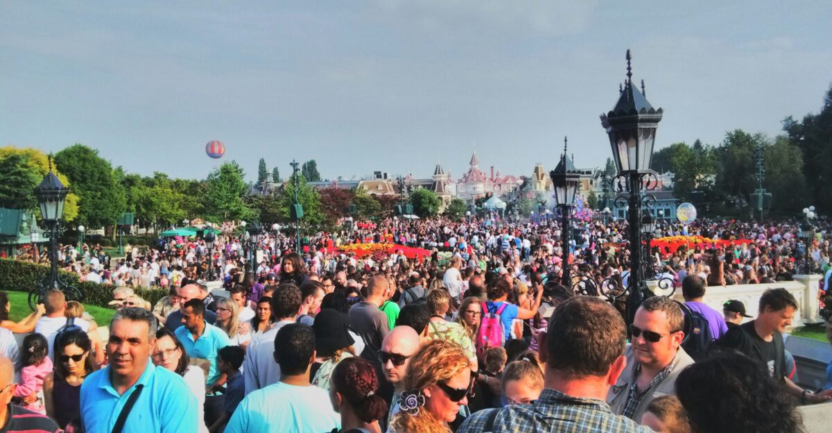 a large group of people standing in a park