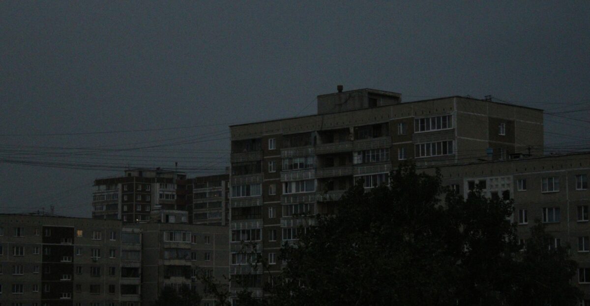 a full moon in the sky over a city