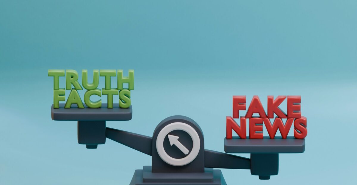 a scale with the words fake news on it