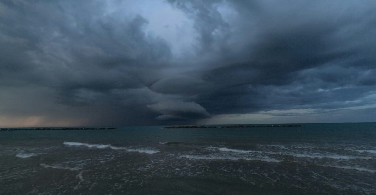 a storm moving across the sky over a body of water