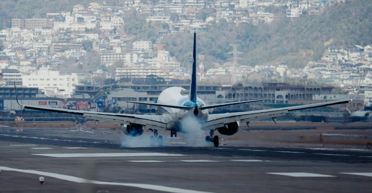 a plane is landing on the runway of an airport