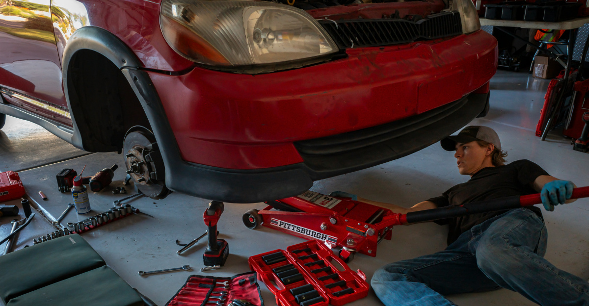 a man working on a car in a garage