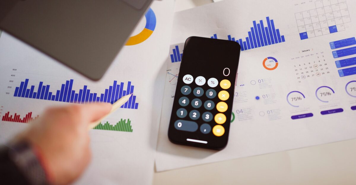 a calculator sitting on top of a table next to a laptop