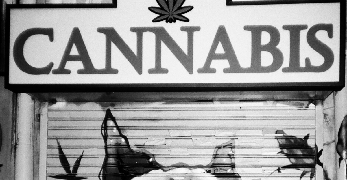 a man sitting on a bench in front of a door