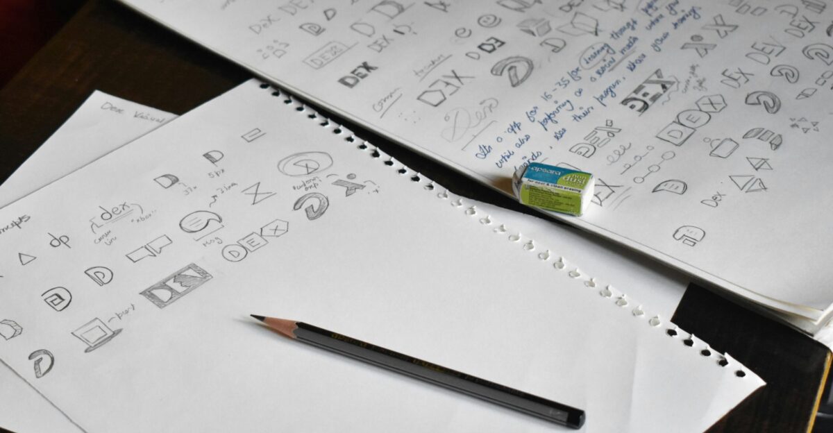 a pencil sitting on top of a pile of paper