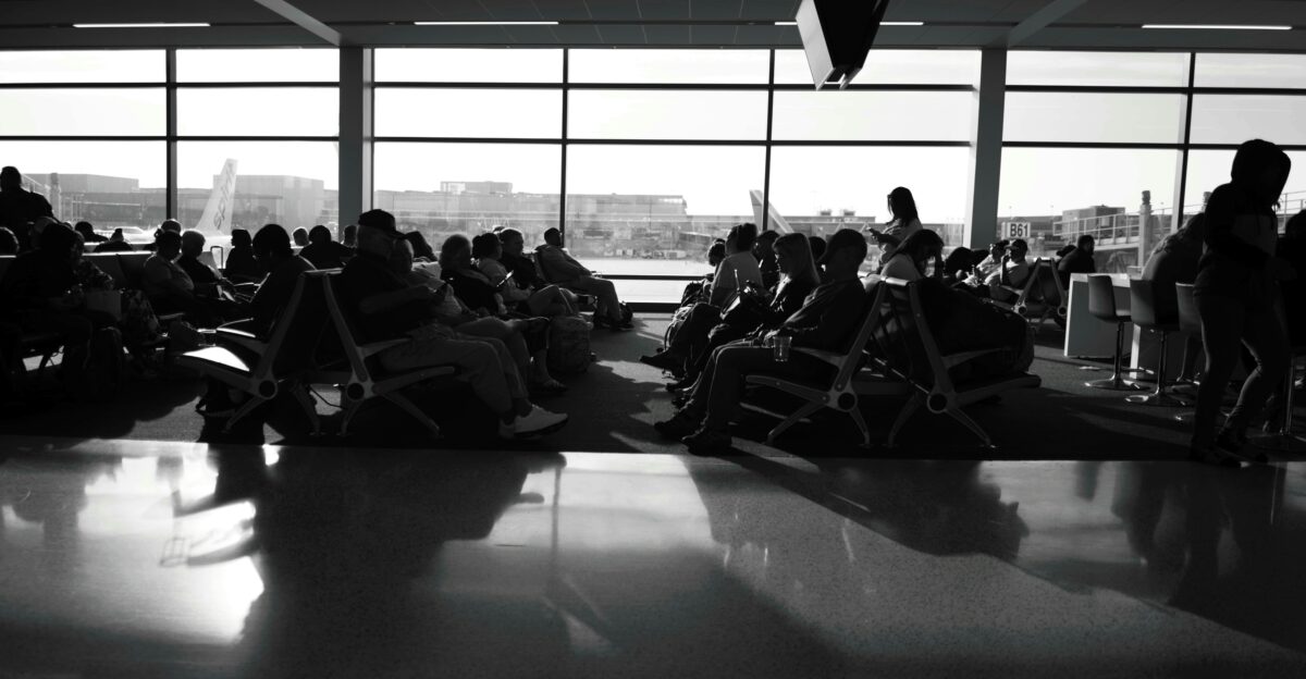 a black and white photo of people sitting in chairs