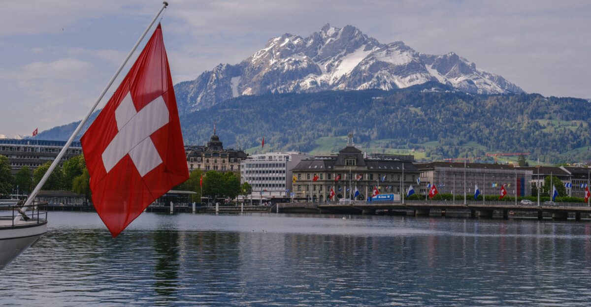 a swiss flag on a boat in the water