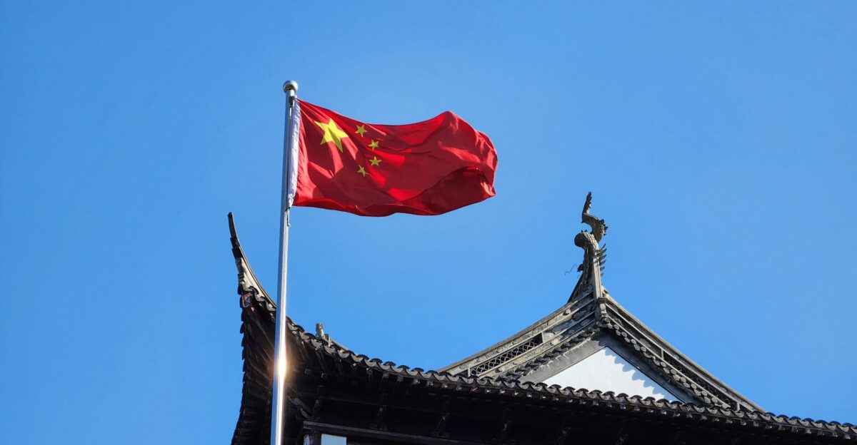 A chinese flag flying on top of a building
