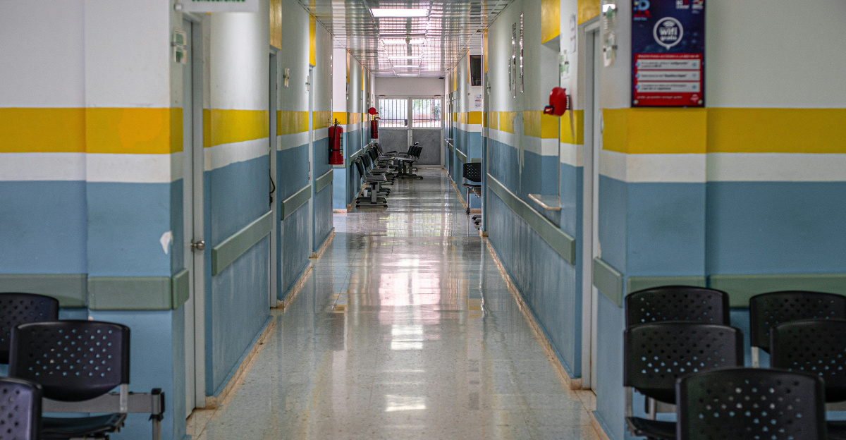 A long hallway with chairs and a clock on the wall