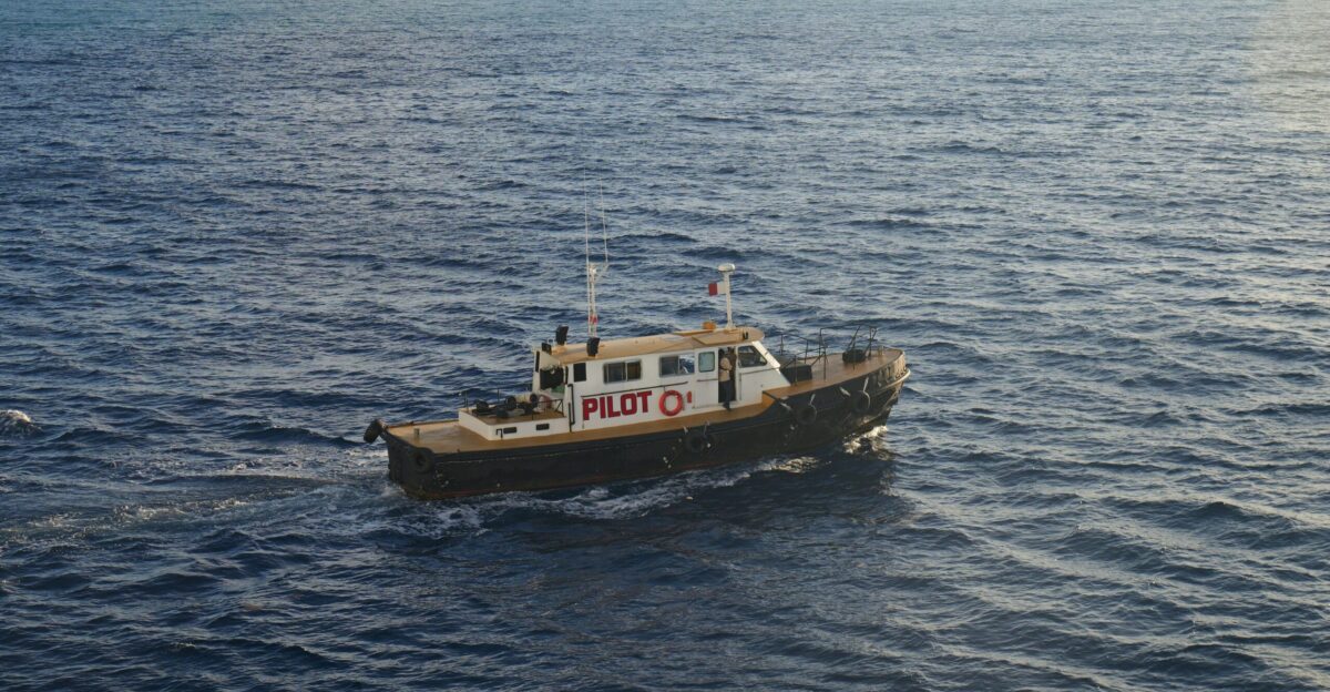 A small boat traveling across a large body of water