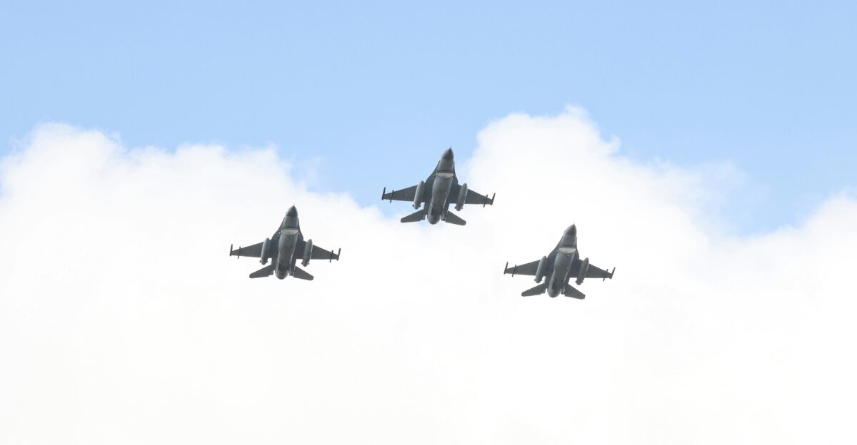 A group of fighter jets flying through a cloudy sky