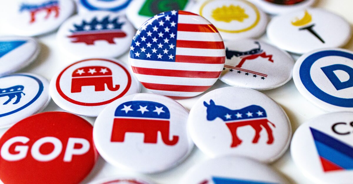 A pile of political buttons sitting on top of a table
