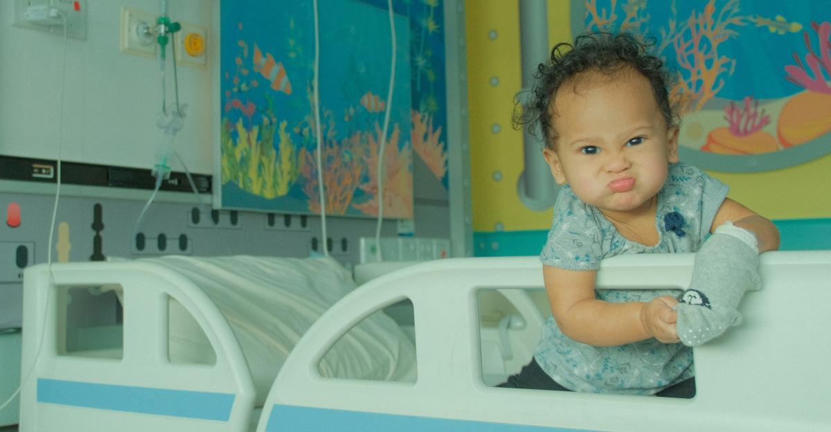 A baby sitting on a bed in a room