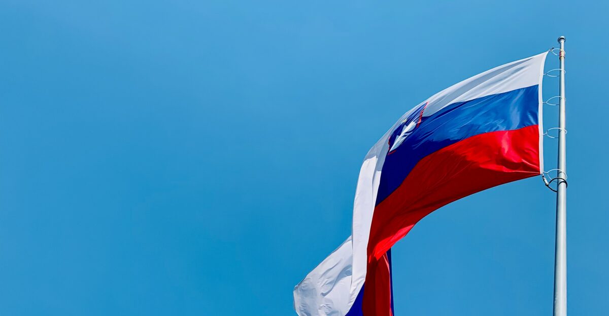 A red white and blue flag flying in the wind