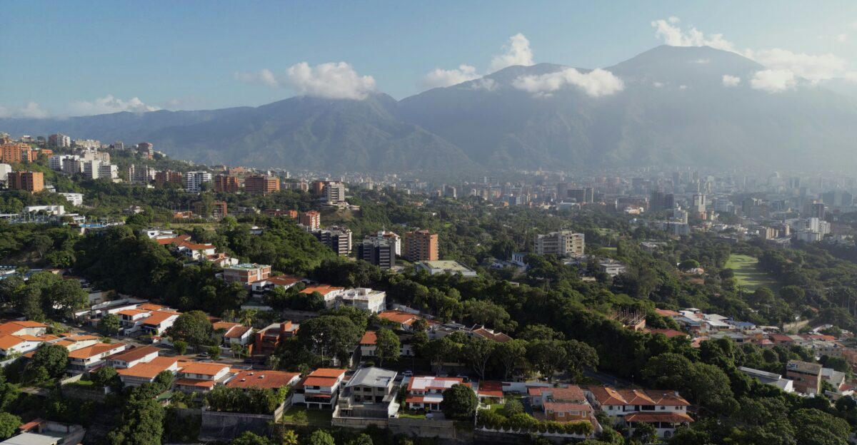 An aerial view of a city with mountains in the background