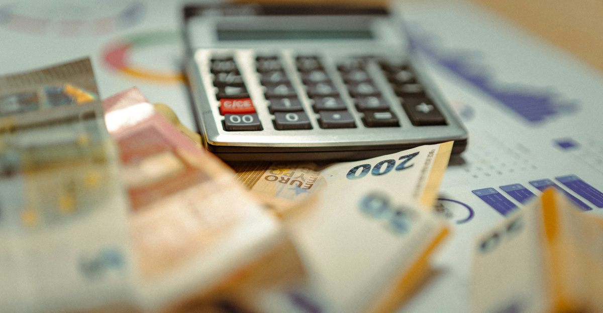 A calculator sitting on top of a pile of money